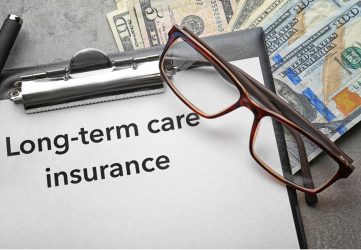 Clipboard holding a paper titled Long-term care insurance with reading glasses and paper money